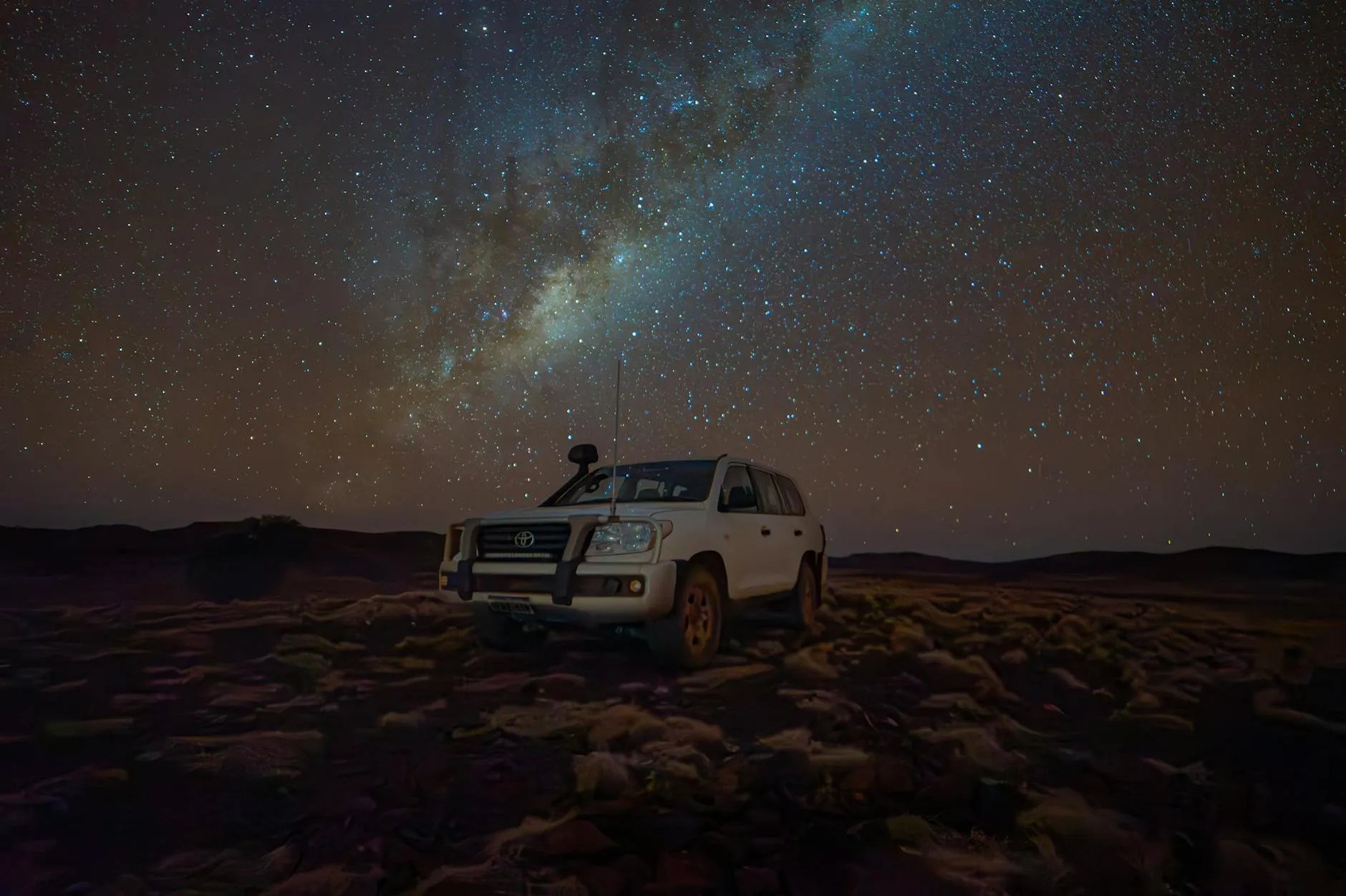 Toyota Land Cruiser 300 Series driving through UAE desert dunes with golden sand